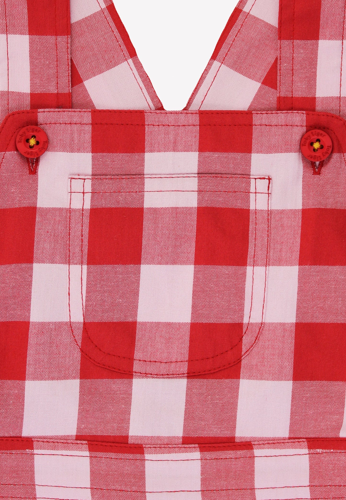 Red and white checkered shirt with button details on a plain background