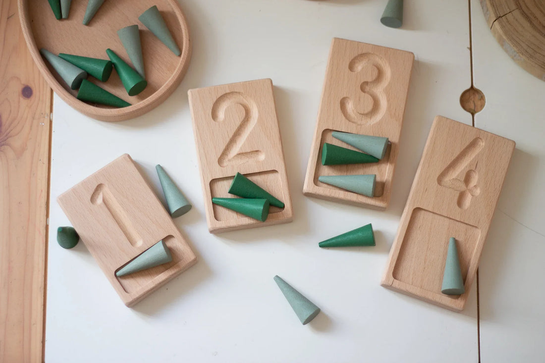 Child playing freely with natural wooden toys on the floor - the importance of play for children's development UK | Kiddykind