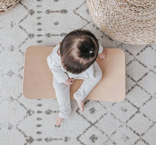 Child balancing on Curve Lab Little Arc wooden balance board - sustainable parenting for babies and kids UK | Kiddykind