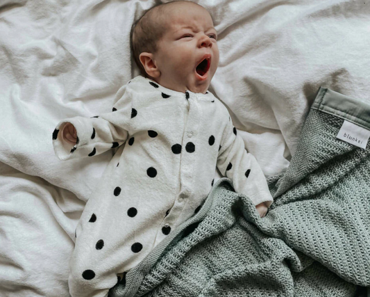 Soft organic cotton cellular blanket folded neatly - safety and benefits of cellular blankets for baby sleep UK | Kiddykind
