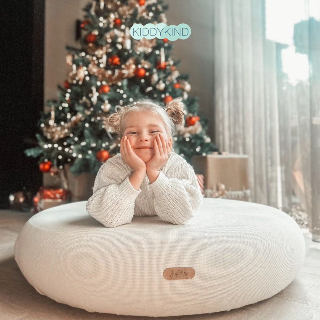 Family decorating a natural Christmas tree with handmade ornaments - eco-friendly Christmas traditions for kids UK | Kiddykind
