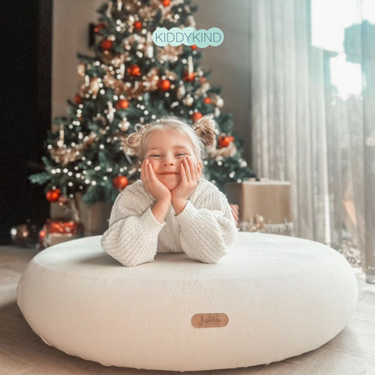 Family decorating a natural Christmas tree with handmade ornaments - eco-friendly Christmas traditions for kids UK | Kiddykind