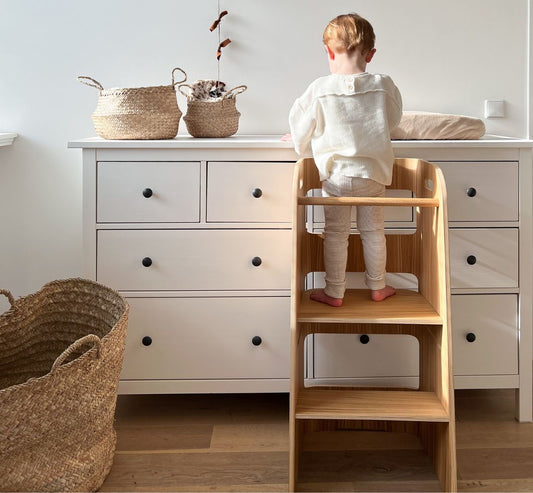 Child engaged in Montessori learning activity with wooden materials - empowering kids for self, others and earth UK | Kiddykind