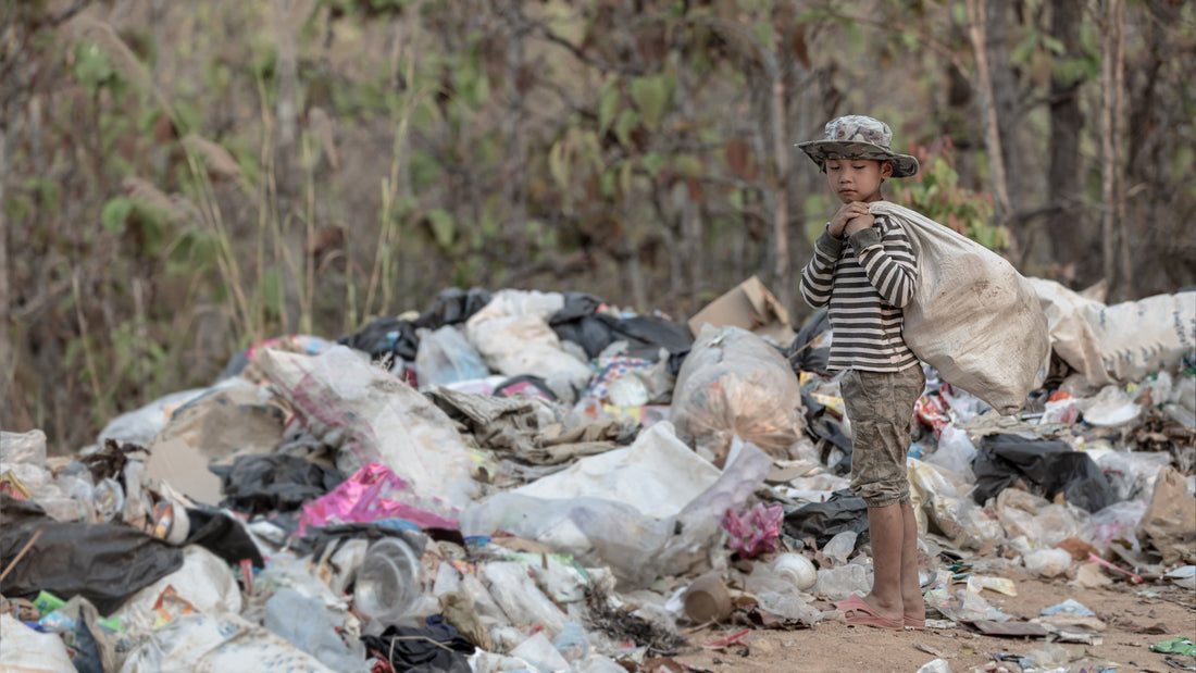 Pile of discarded fast fashion clothing in landfill - why fast fashion is ruining our planet and what to do UK | Kiddykind