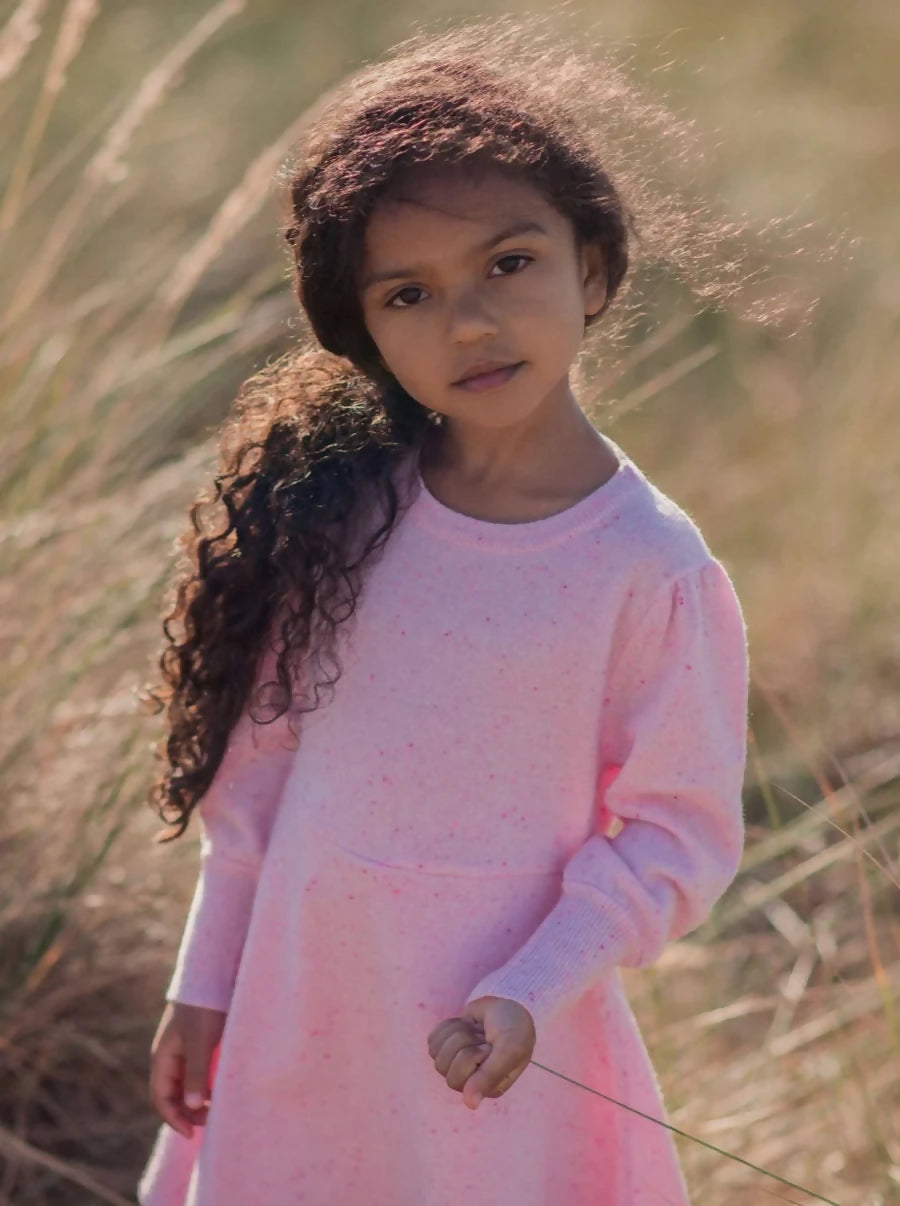 Girl in pink organic cotton Mika and Milo dress in a meadow - sustainable ethical kids clothing UK | Kiddykind