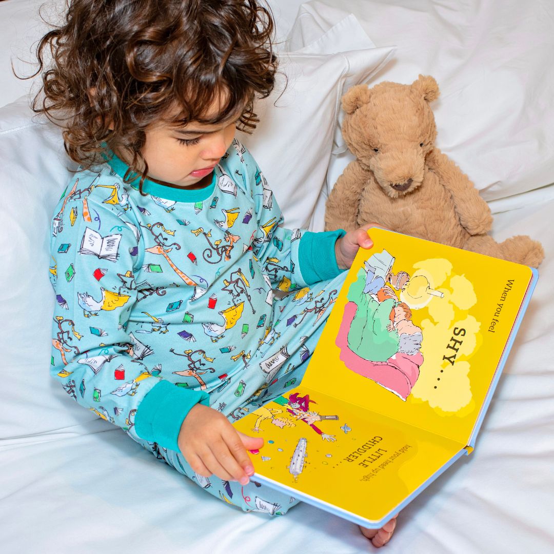 Child reading in Ducky Zebra organic cotton pyjamas - sustainable ethical kids clothing UK | Kiddykind