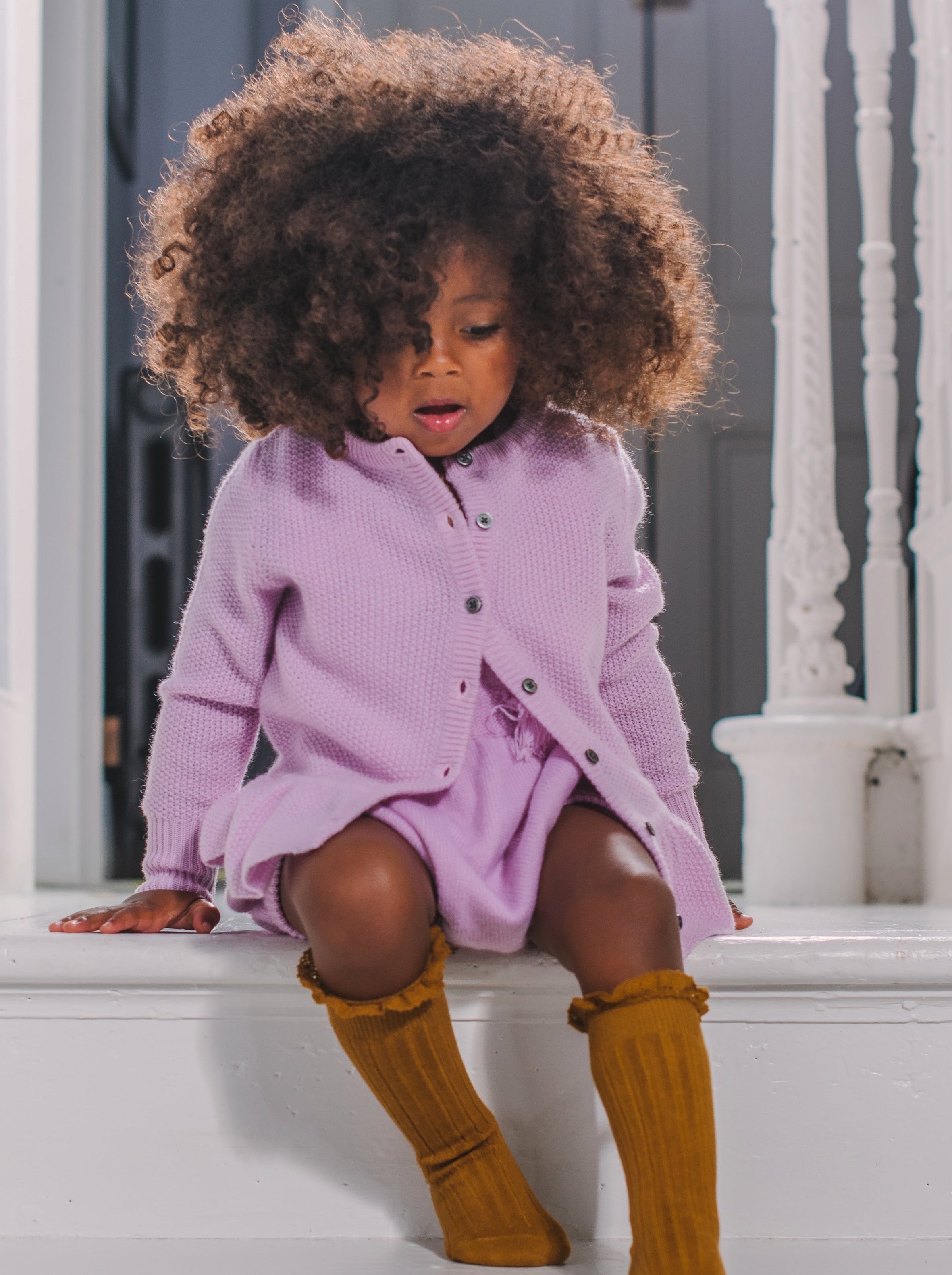 This stylish 4 ply cardigan in Moss Stitch comes with a lovely stylish ruffle at the bottom. Made with pure 100% cashmere from Inner Mongolia, it will keep your Little One stylish and warm all winter long. 