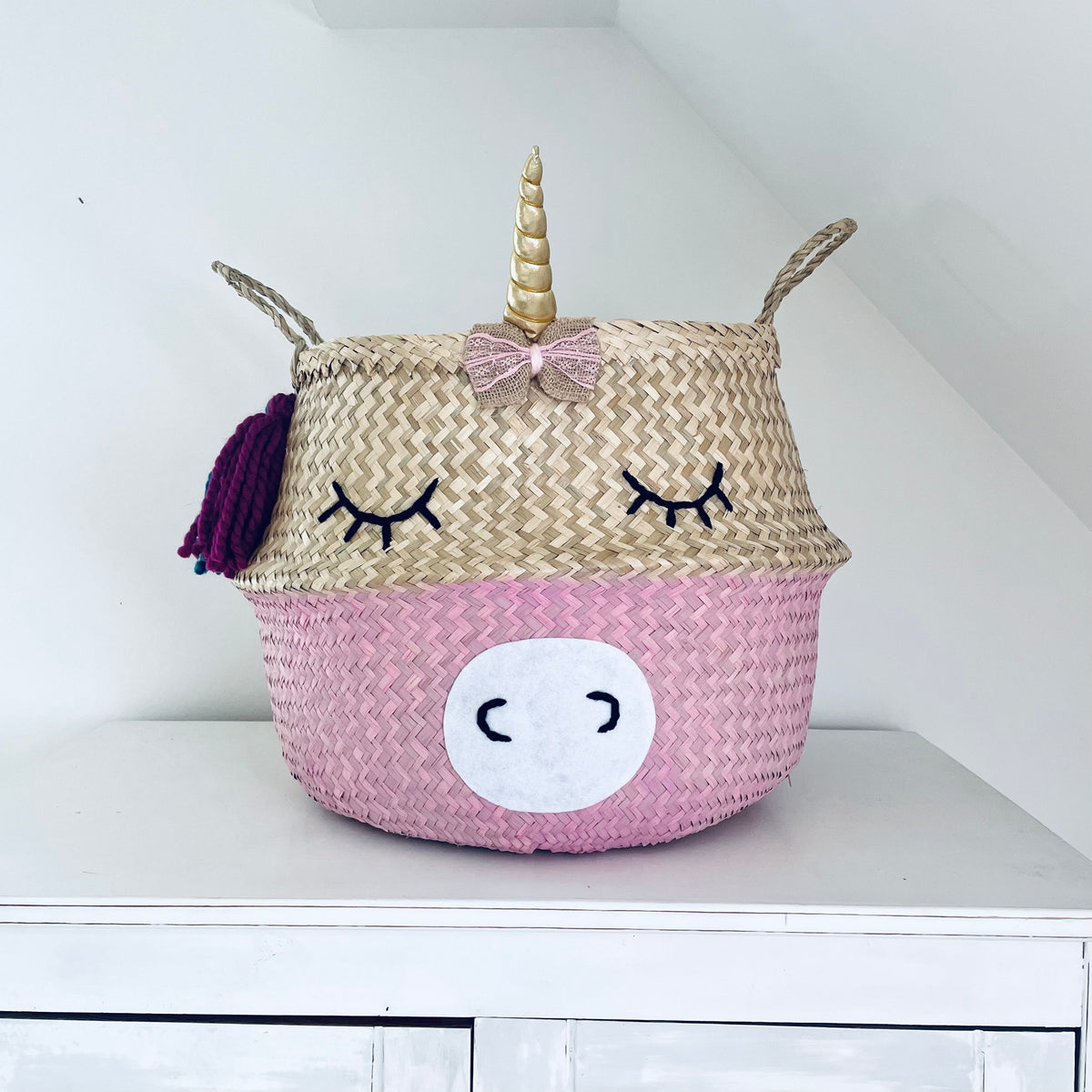 Handwoven seagrass unicorn storage basket with rainbow hair and horn