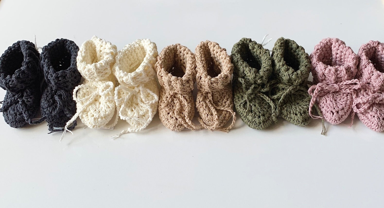 neutral and natural organic cotton crocheted baby booties.