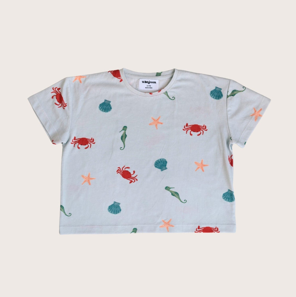 Wildgreen’s Marine T-shirt, a gender-neutral kids' tee made from 100% GOTS-certified organic cotton. Featuring an ocean-inspired print, this sustainable and eco-friendly piece is perfect for conscious families. #OrganicKidswear #SustainableFashion #EthicalClothing