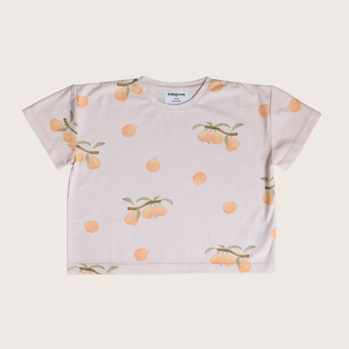 Wildgreen’s Apricot T-shirt, a gender-neutral kids’ tee made from 100% GOTS-certified organic cotton. Featuring a peach hued fruit inspired design, this sustainable and ethical kidswear piece is soft, breathable, and perfect for everyday wear. #OrganicKidswear #SustainableFashion #EthicalClothing