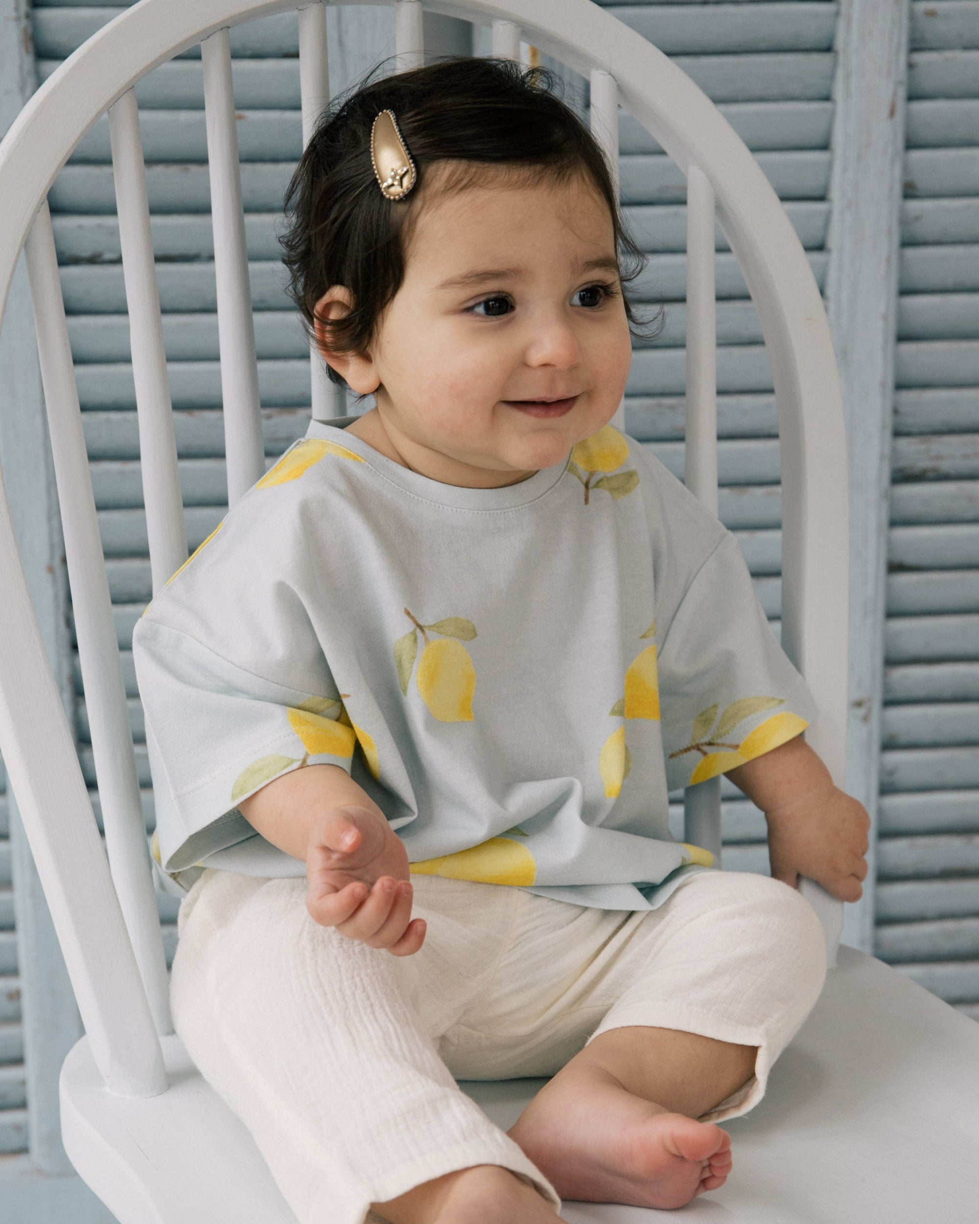 Baby wearing a Wildgreen Lemon T-shirt from the Island Life collection. Made from 100% GOTS-certified organic cotton, this gender-neutral kids’ tee features a zesty lemon print, perfect for eco-conscious families who value sustainable fashion. #OrganicKidsClothing #SustainableKidswear