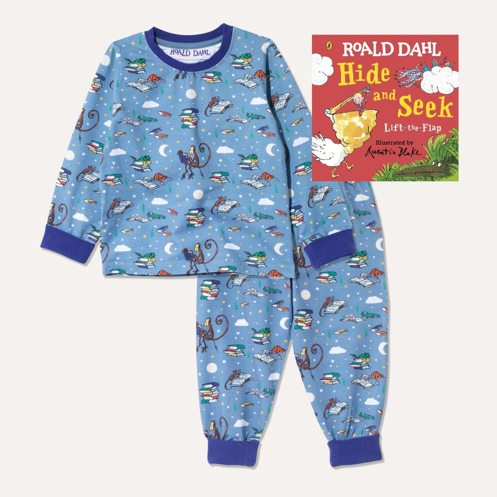 Image of Roald Dahl's 'Hide and Seek' board book alongside a pair of Ducky Zebra x Roald Dahl purple/blue pyjamas with an all over print of various animals from Roald Dahl stories reading books together