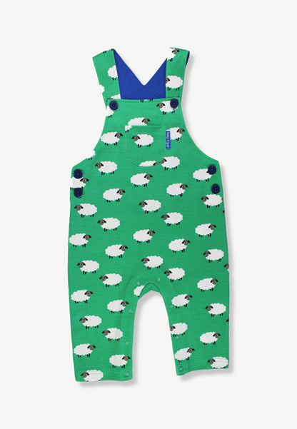 Green baby overalls with a white sheep pattern, featuring a blue V-neck interior and shoulder straps, shown flat on a light gray background.