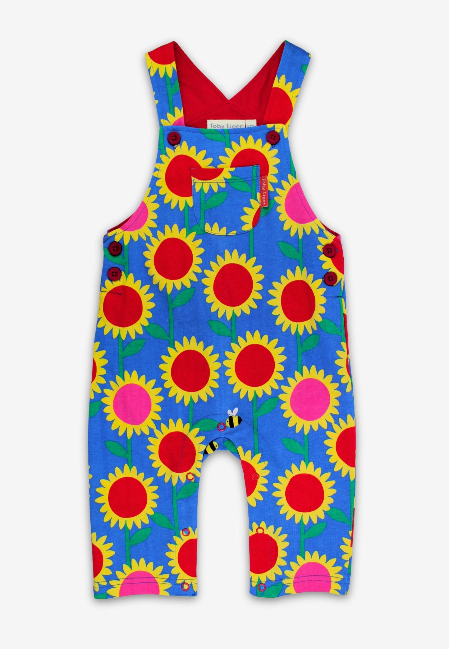 Colorful children's overalls with sunflower pattern on a white background