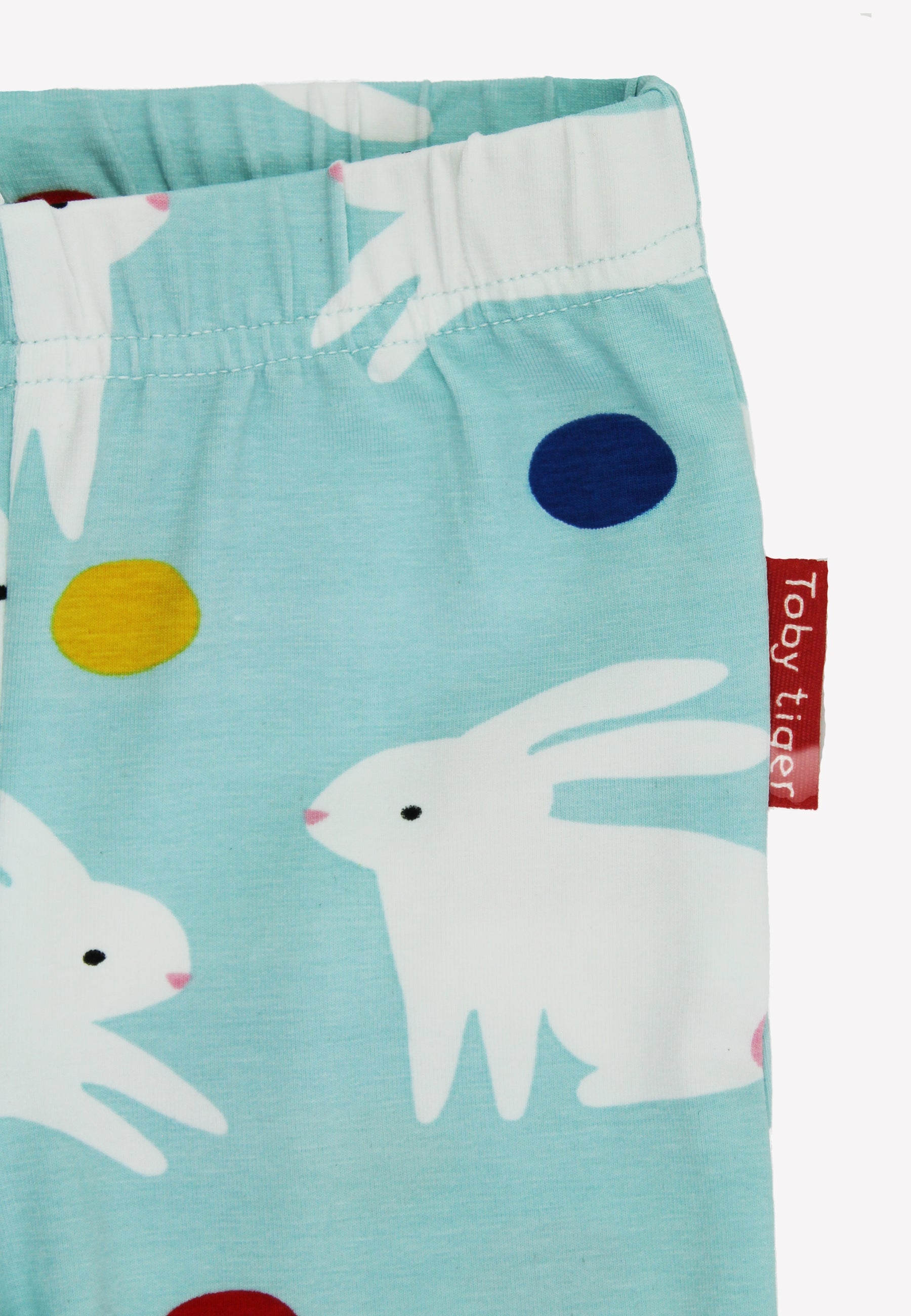 Children's leggings with rabbit pattern and Toby Tiger tag on a light blue background