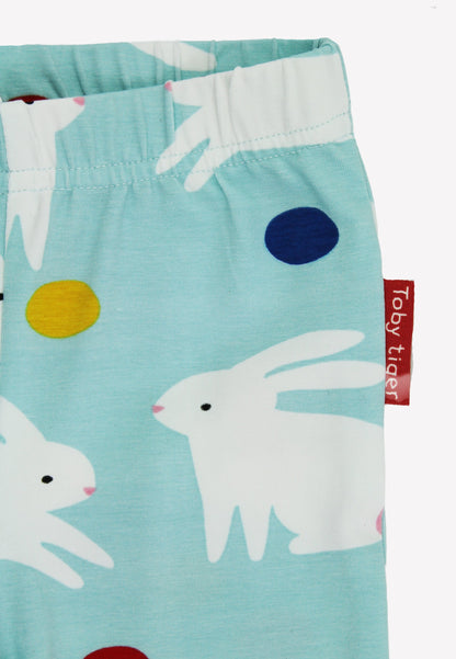 Children's leggings with rabbit pattern and Toby Tiger tag on a light blue background