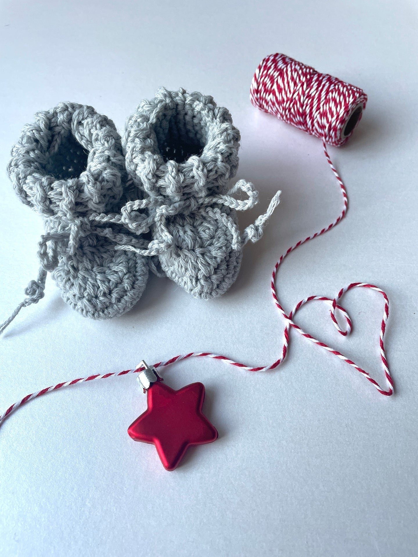 image shows light grey organic wool baby booties