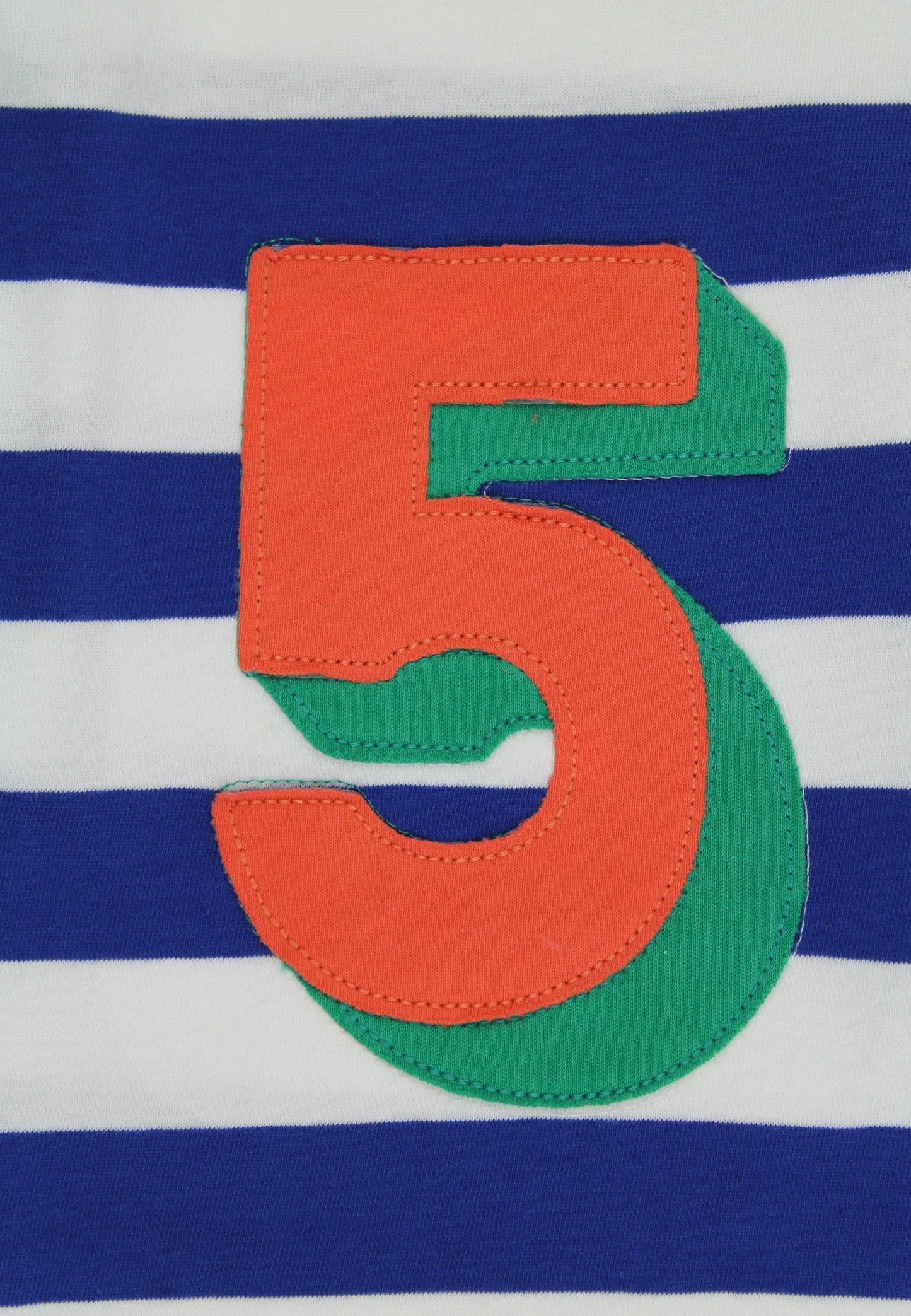 Orange and green number 5 on a blue and white striped background