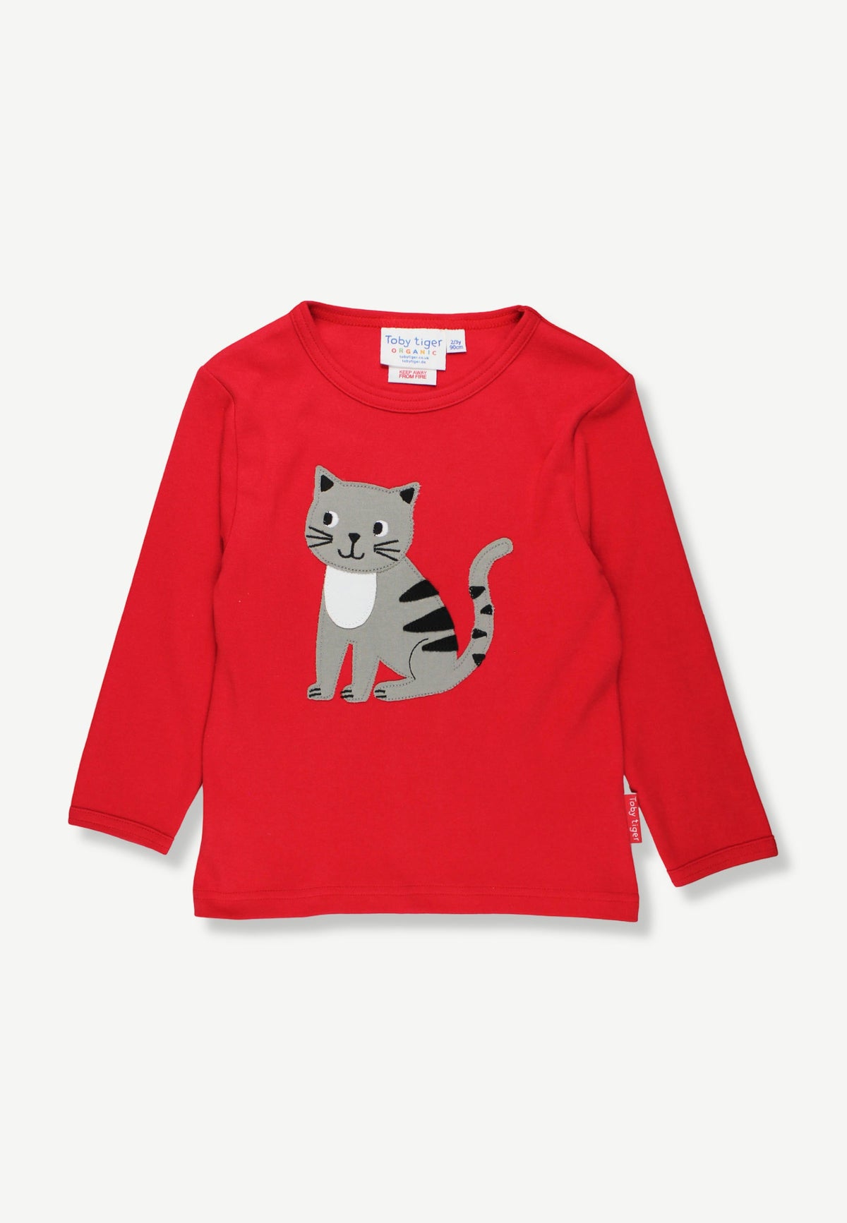 A red long-sleeve children's t-shirt featuring a cartoon cat graphic on the front, displayed flat against a light gray background.