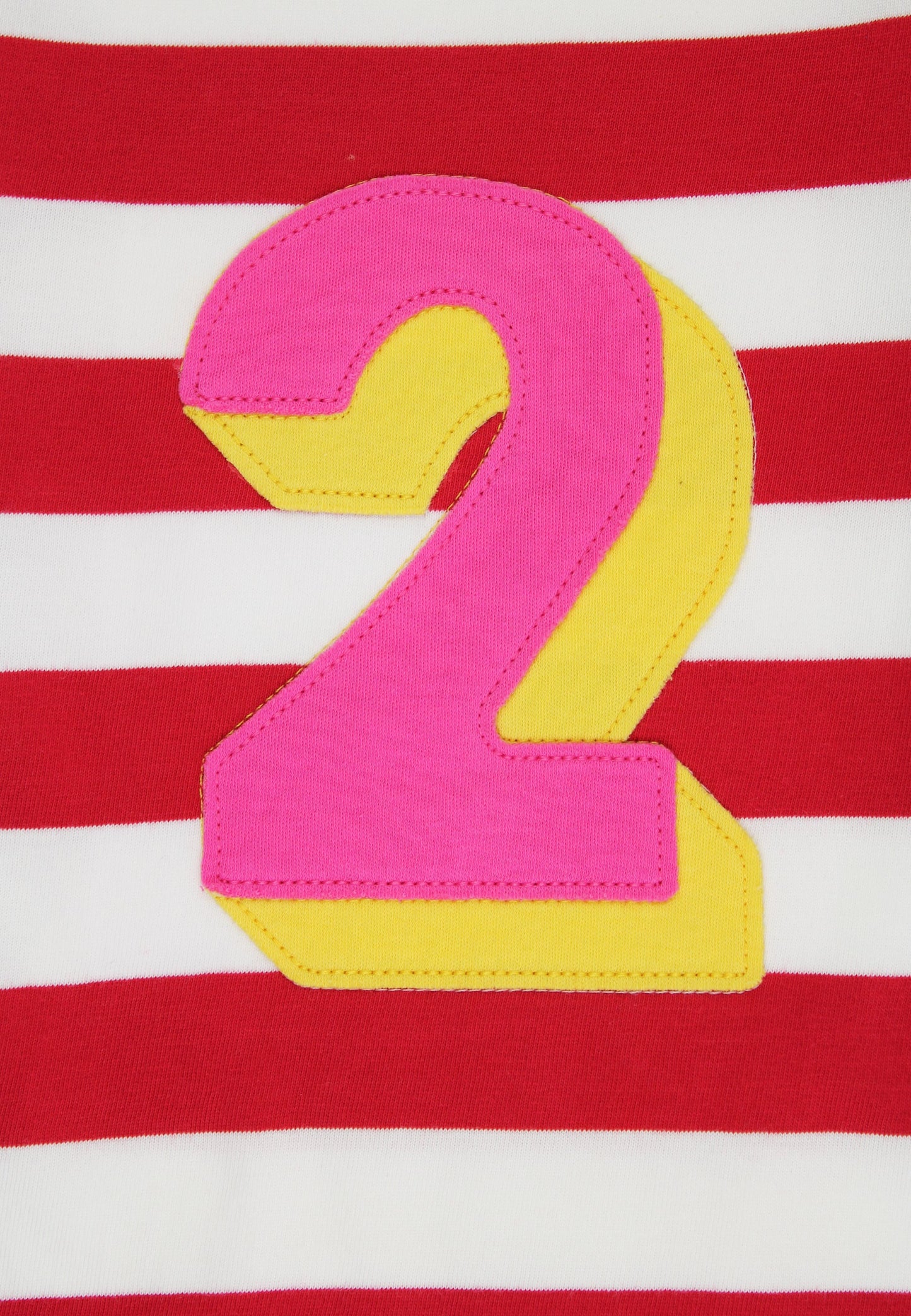 Pink and yellow number '2' on a red and white striped background
