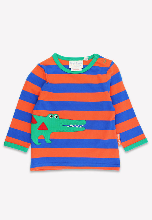 Children's long-sleeve shirt with red and blue stripes and a green alligator design on a white background