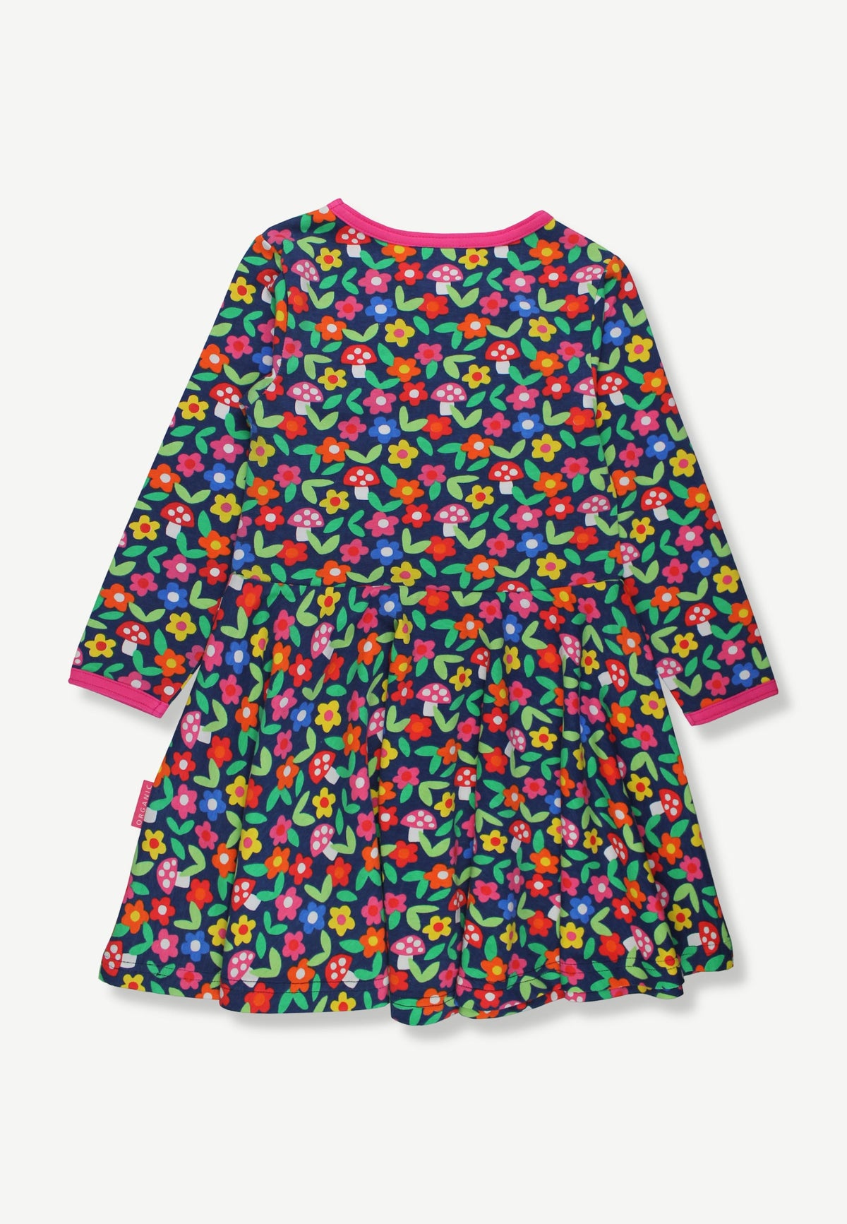 A long-sleeve children's dress with a dense multicolor floral print on a dark green background, featuring bright pink collar and cuff trim, shown flat against a light gray background.