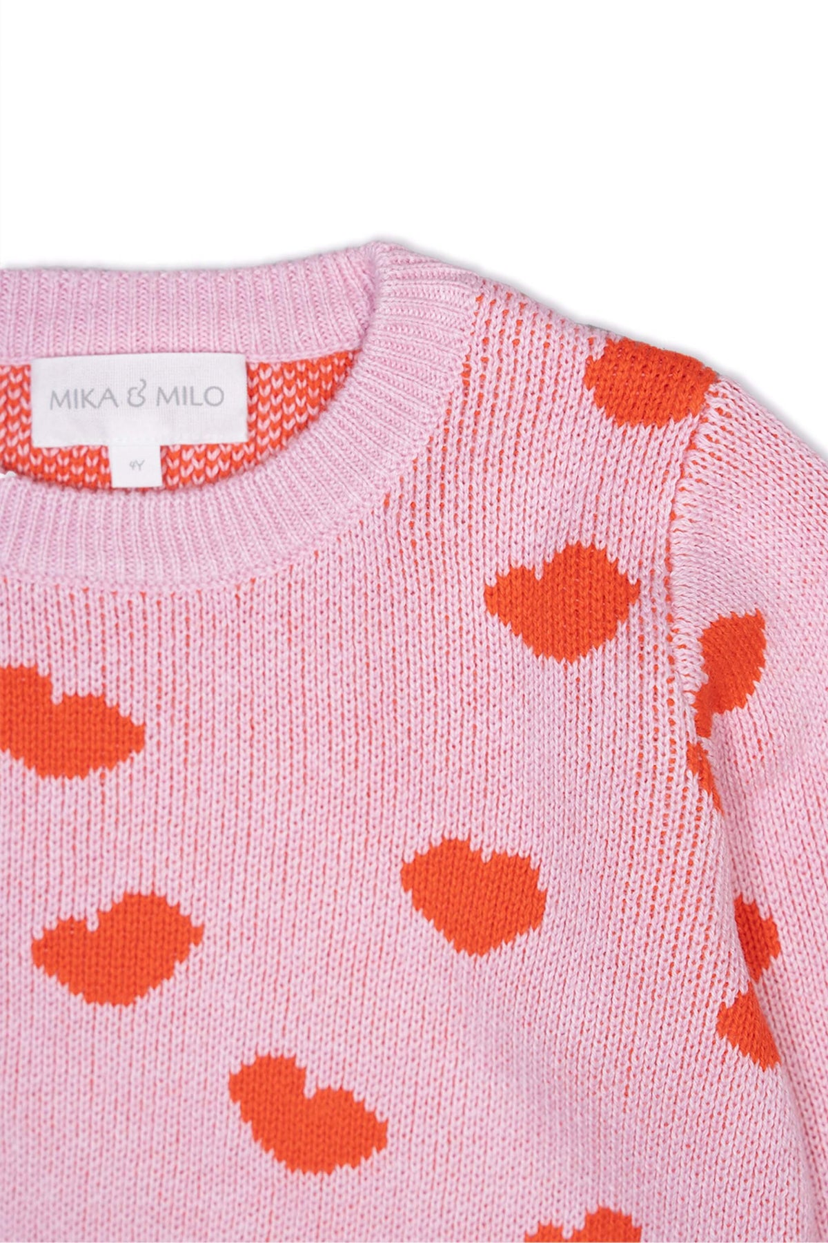 Close-up of the jacquard-knit hearts on the bubble gum pink jumper