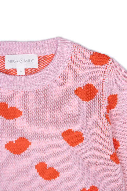 Close-up of the jacquard-knit hearts on the bubble gum pink jumper