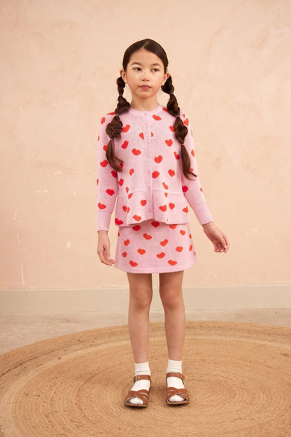 Girl wearing the MIKA & MILO Love Hearts Peplum Cardigan in bubble gum pink
