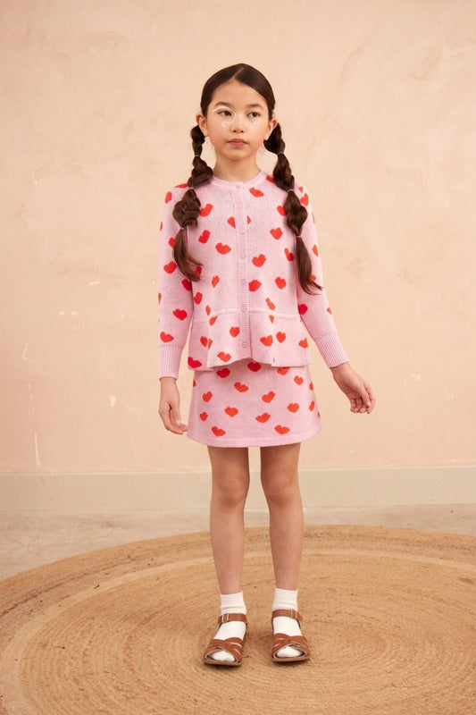 Girl wearing the MIKA & MILO Love Hearts Peplum Cardigan in bubble gum pink