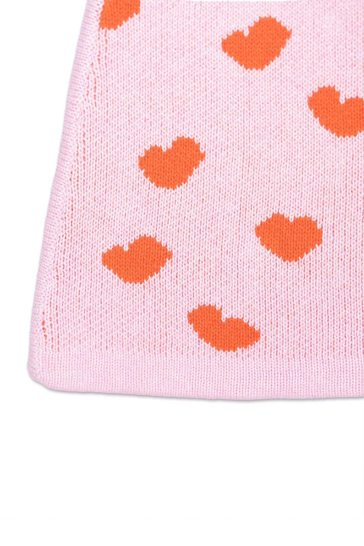 Close-up of the jacquard-knit hearts on the bubble gum pink skirt