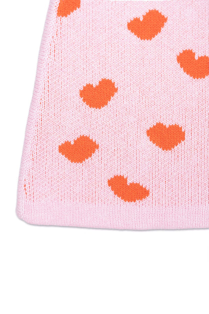 Close-up of the jacquard-knit hearts on the bubble gum pink skirt