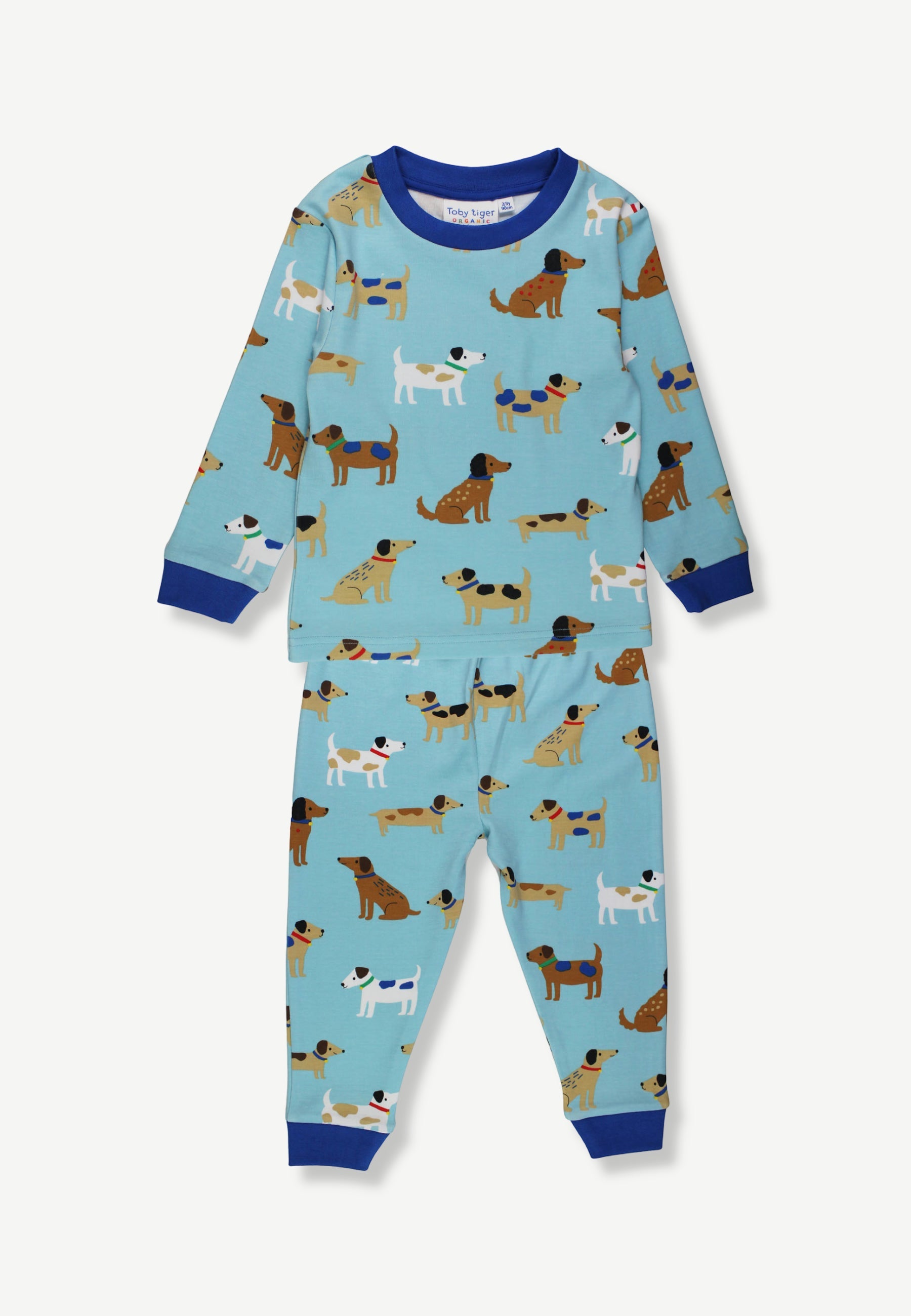 A two-piece baby pajama set featuring a light blue long-sleeve top and matching pants, both printed with a pattern of various dog illustrations. The set has dark blue ribbed cuffs, collar, and hem, and is displayed flat against a light off-white background.