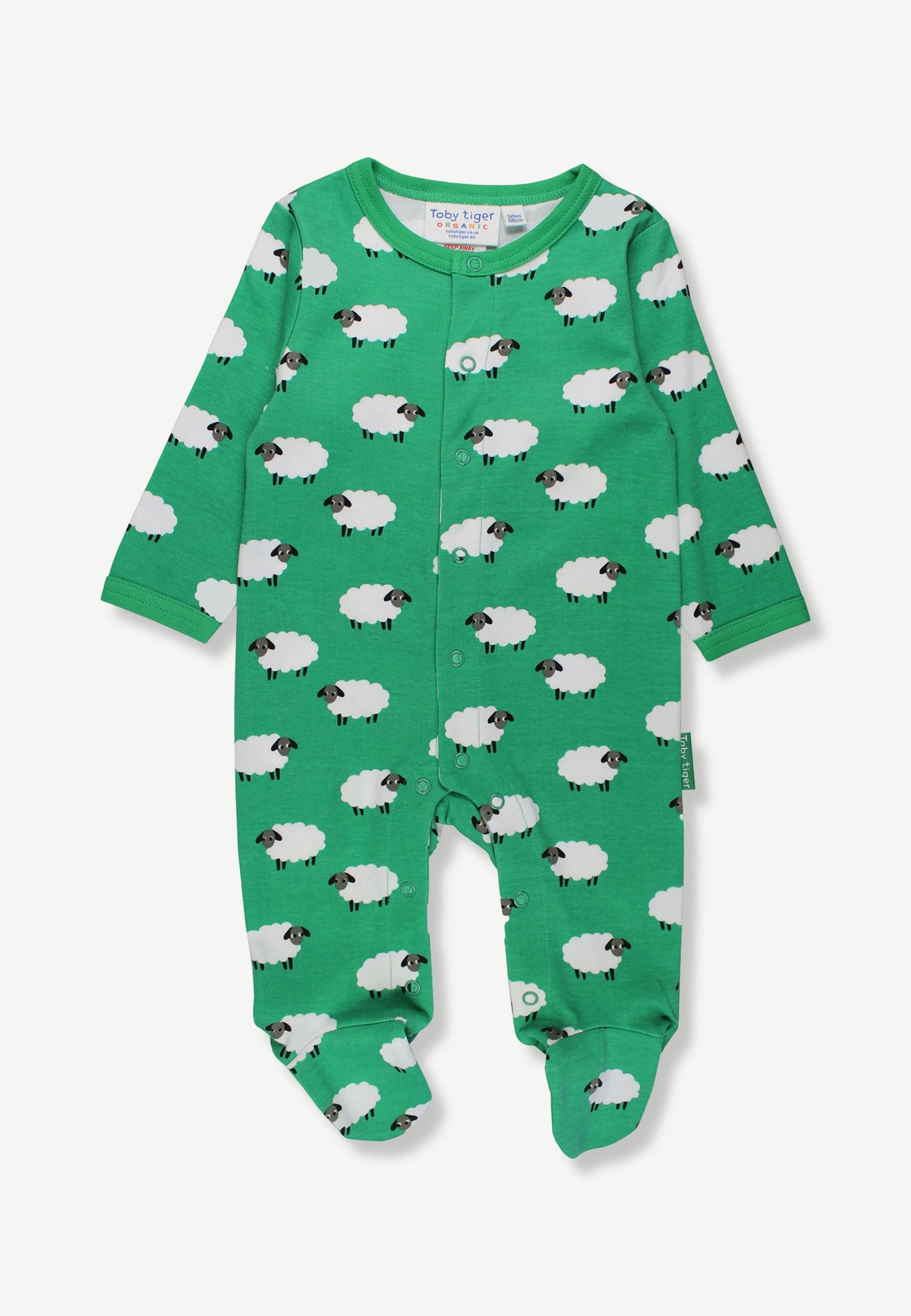 A baby long-sleeve footed sleeper in bright green, featuring an all-over white sheep print with black faces, shown flat on a light gray background.