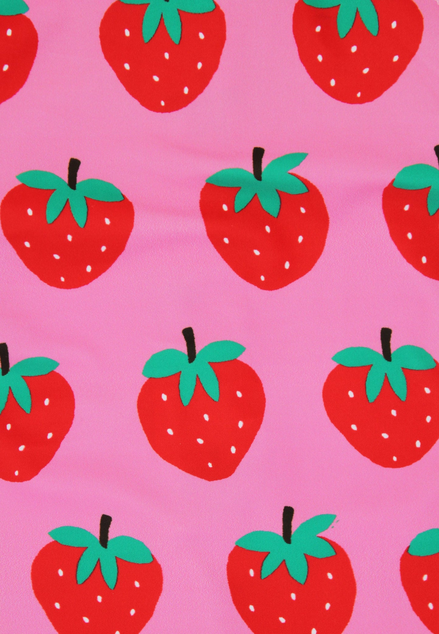 Pattern of red strawberries with green leaves on a pink background