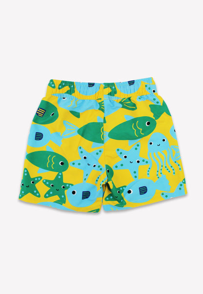Yellow board shorts with green and blue fish and sea creatures print.