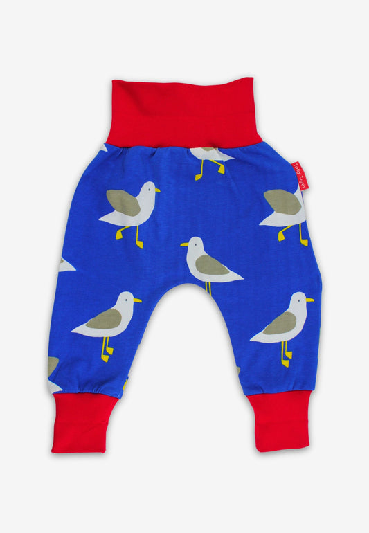 Blue baby trousers with seagull pattern and red accents on a white background