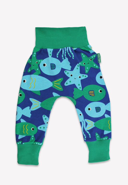 Children's pants with fish and starfish pattern on a blue background