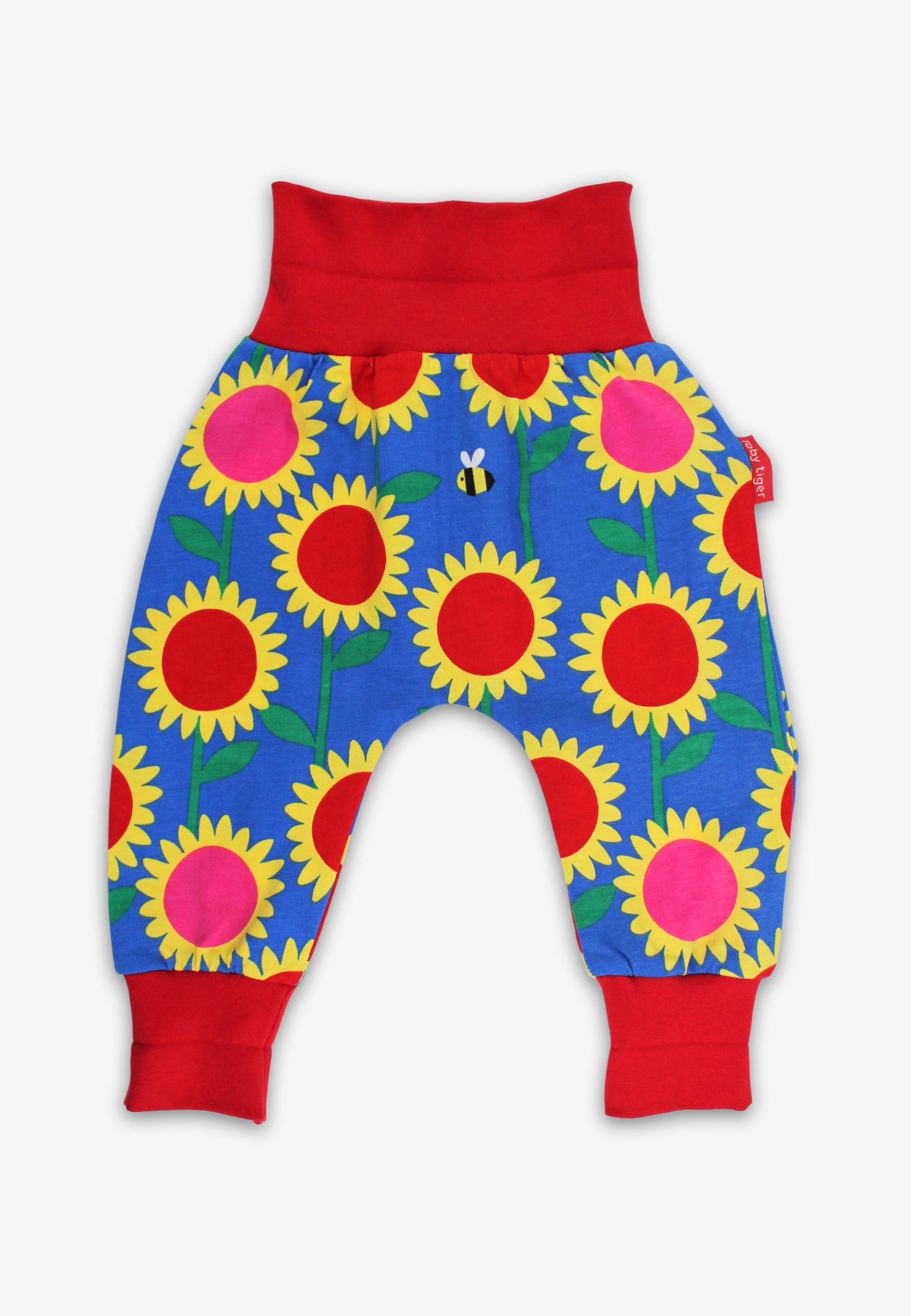 Colorful baby pants with sunflower pattern on a white background