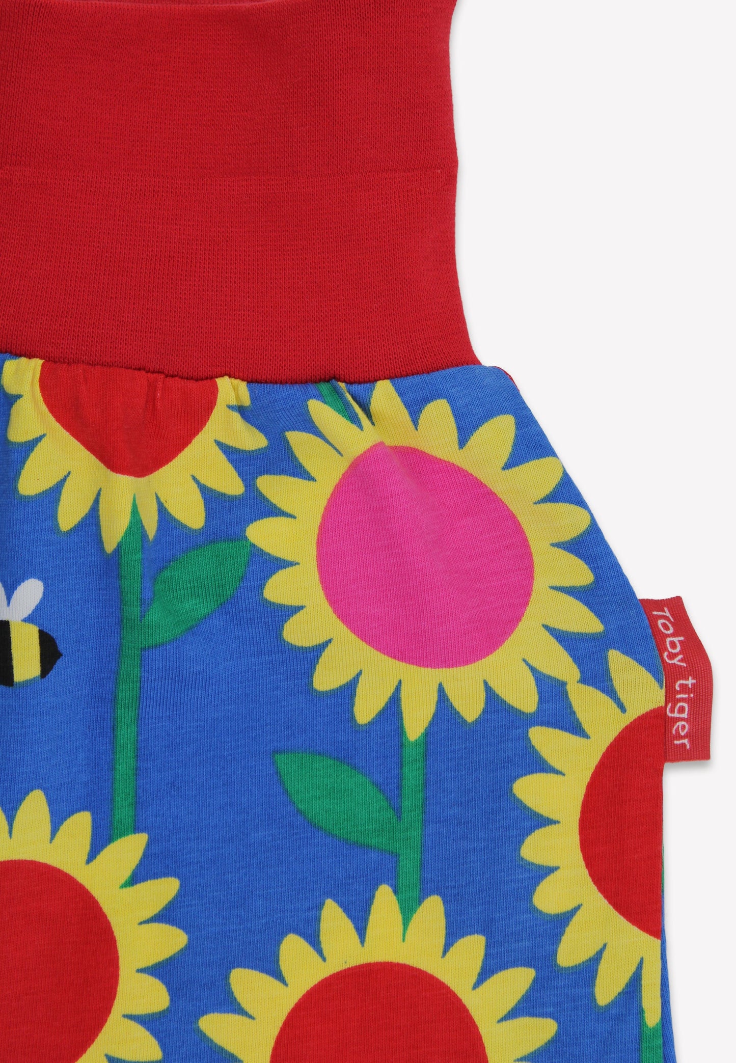Children's dress with red top and blue floral skirt featuring sunflowers and bees, with a visible tag.