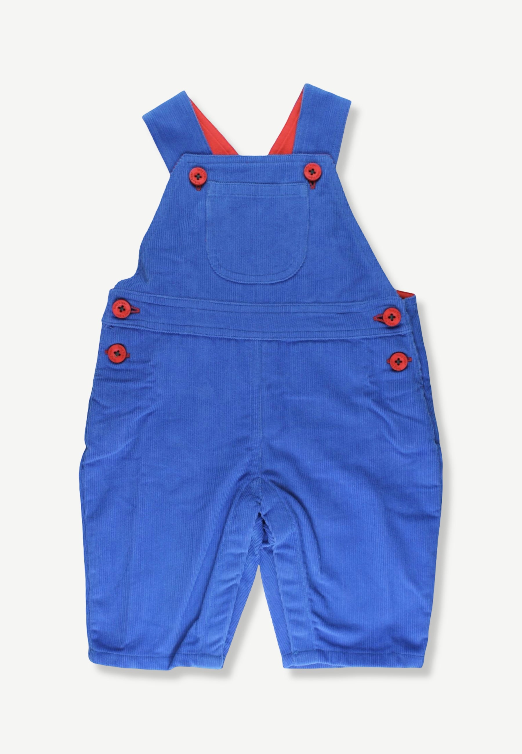 A pair of blue corduroy baby overalls with red buttons and red inner shoulder straps, laid flat on a light off-white background.