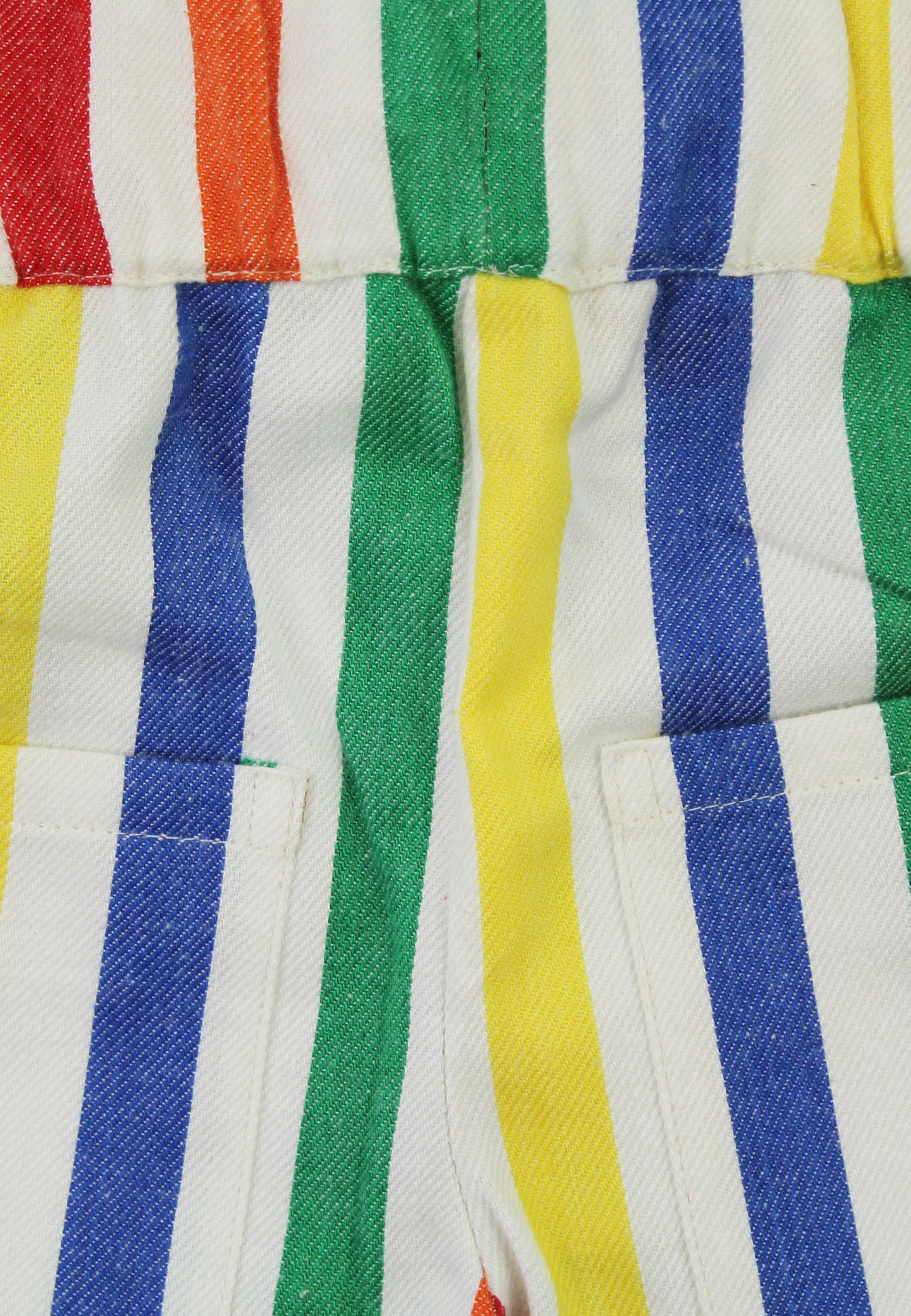 Close-up of colorful striped fabric with red, orange, green, yellow, and blue stripes.