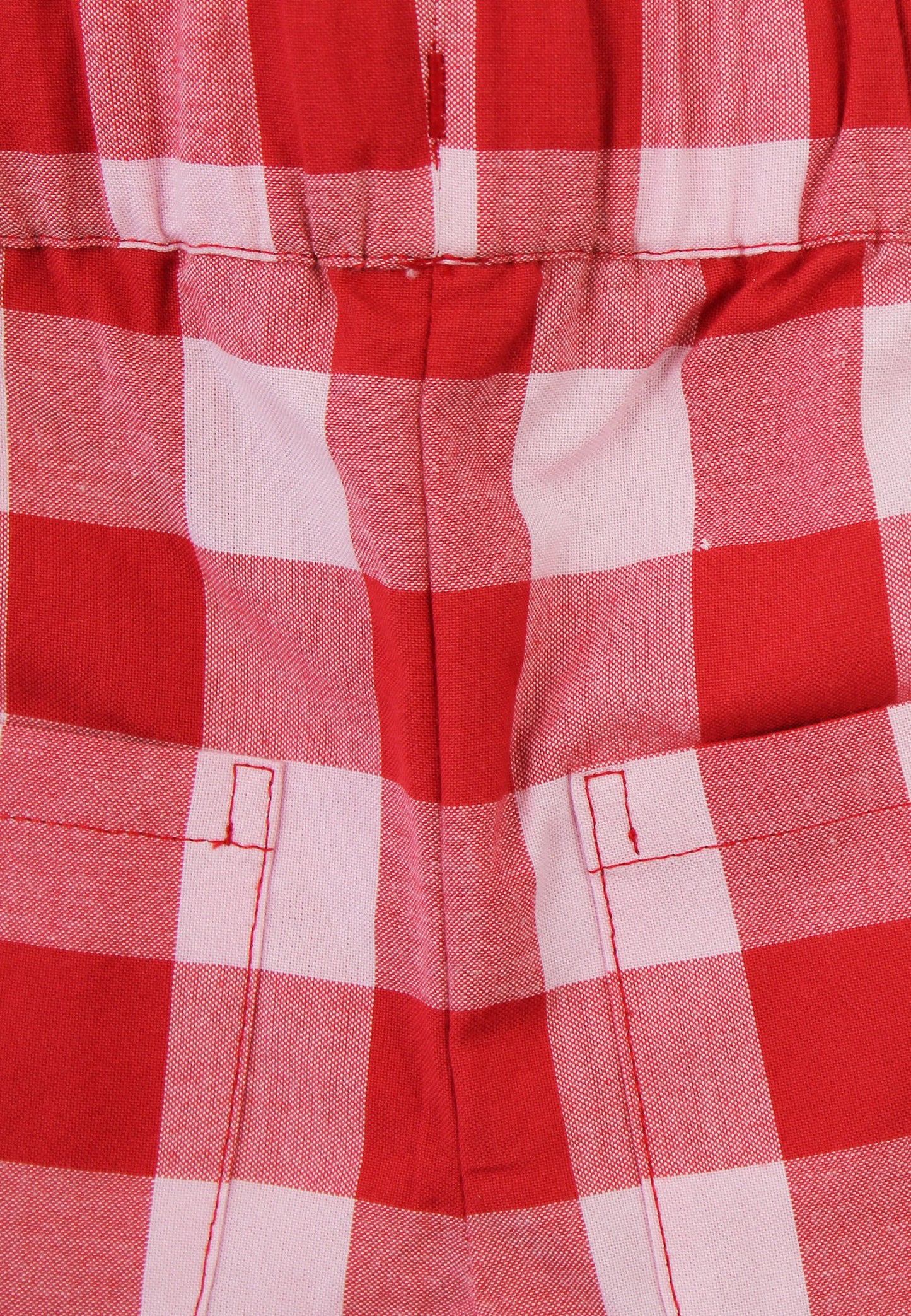 Close up of red and white checkered shorts on a white background