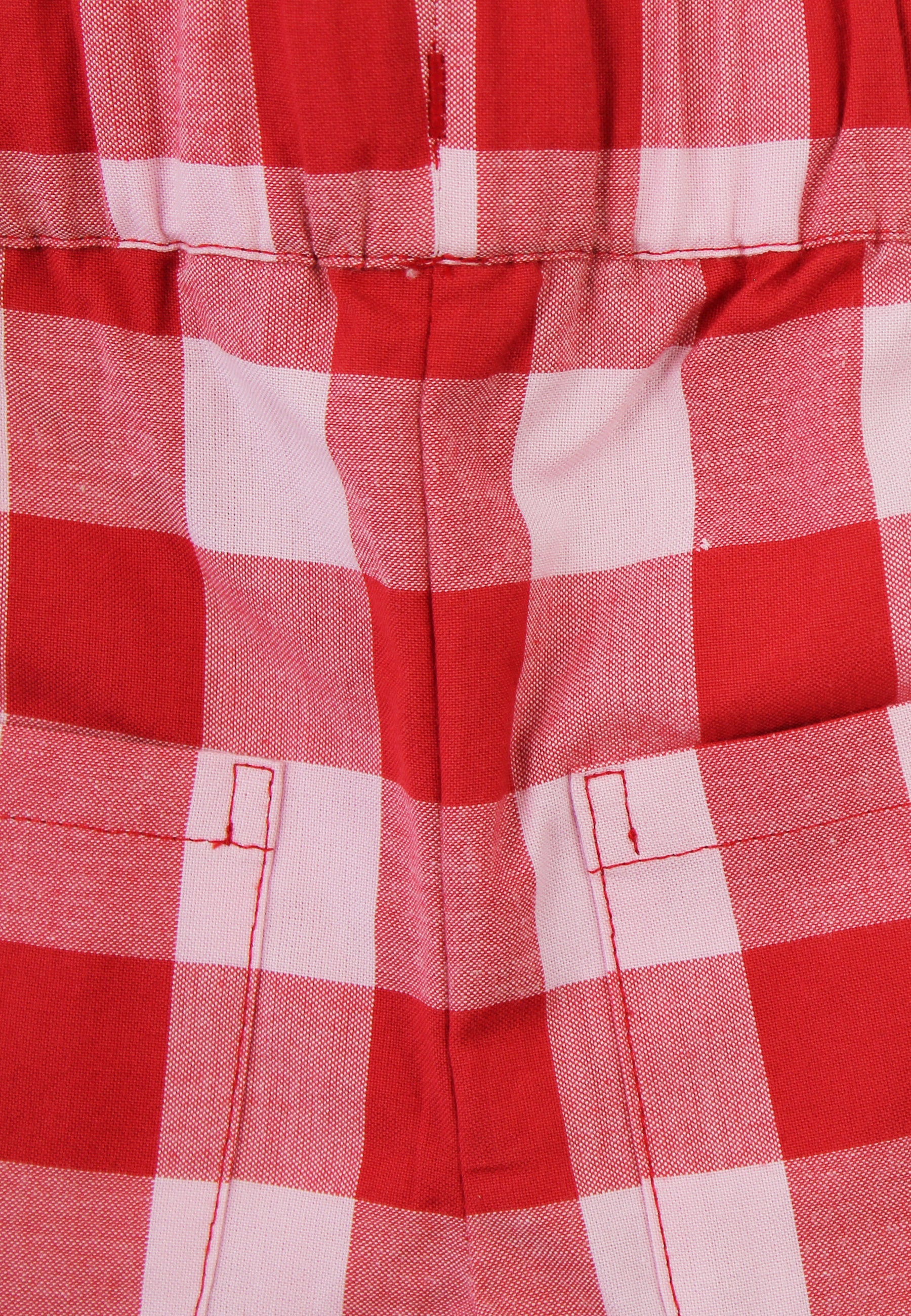 Close up of red and white checkered shorts on a white background