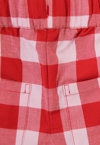 Close up of red and white checkered shorts on a white background